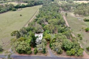 A four-bedroom cottage for sale in Central Queensland is very much "nestled into nature", with the property only visible from an aerial view.