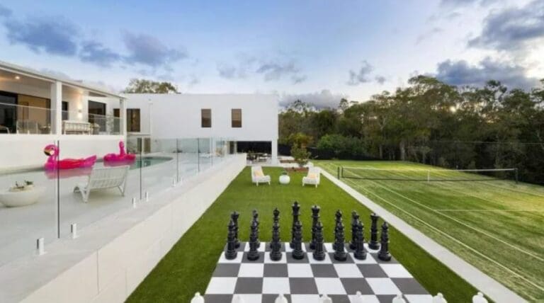 House with a tennis court and giant outdoor chess board